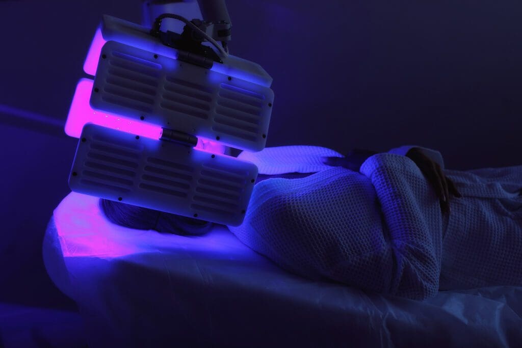 Person receiving LED light facial therapy