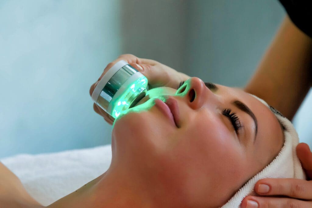 Woman receiving green LED skin treatment