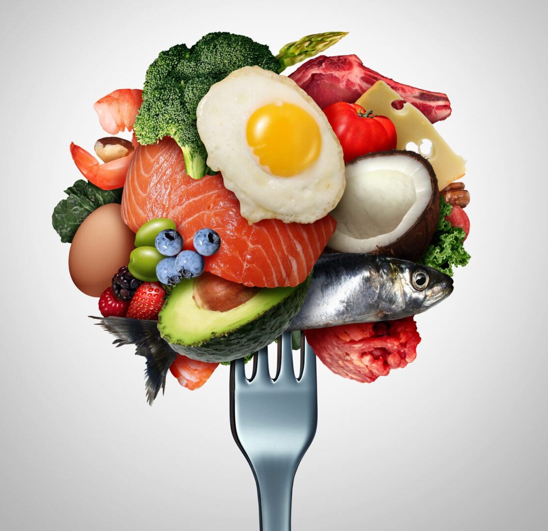 Fork holding assorted healthy proteins and produce