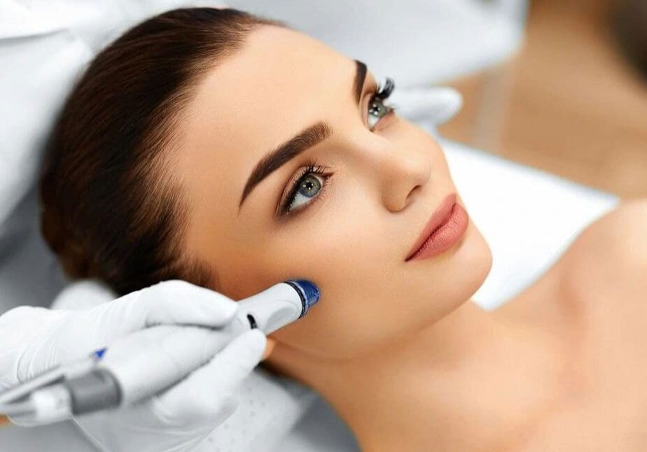 Woman receiving cosmetic facial skin treatment